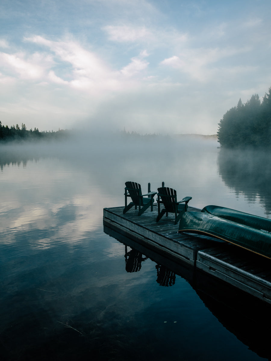 Misty cottage dock with Muskoka chairs 